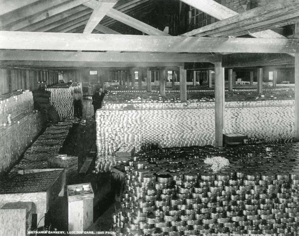Stacks of salmon cans piled on floor of historic cannery