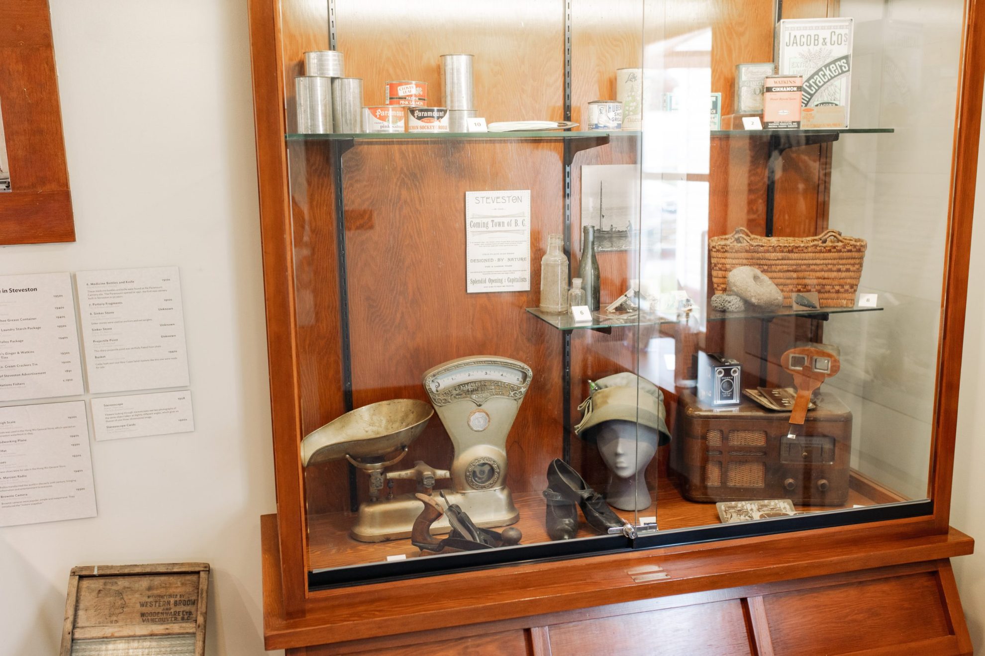 Collection of old household artefacts on display in glass case