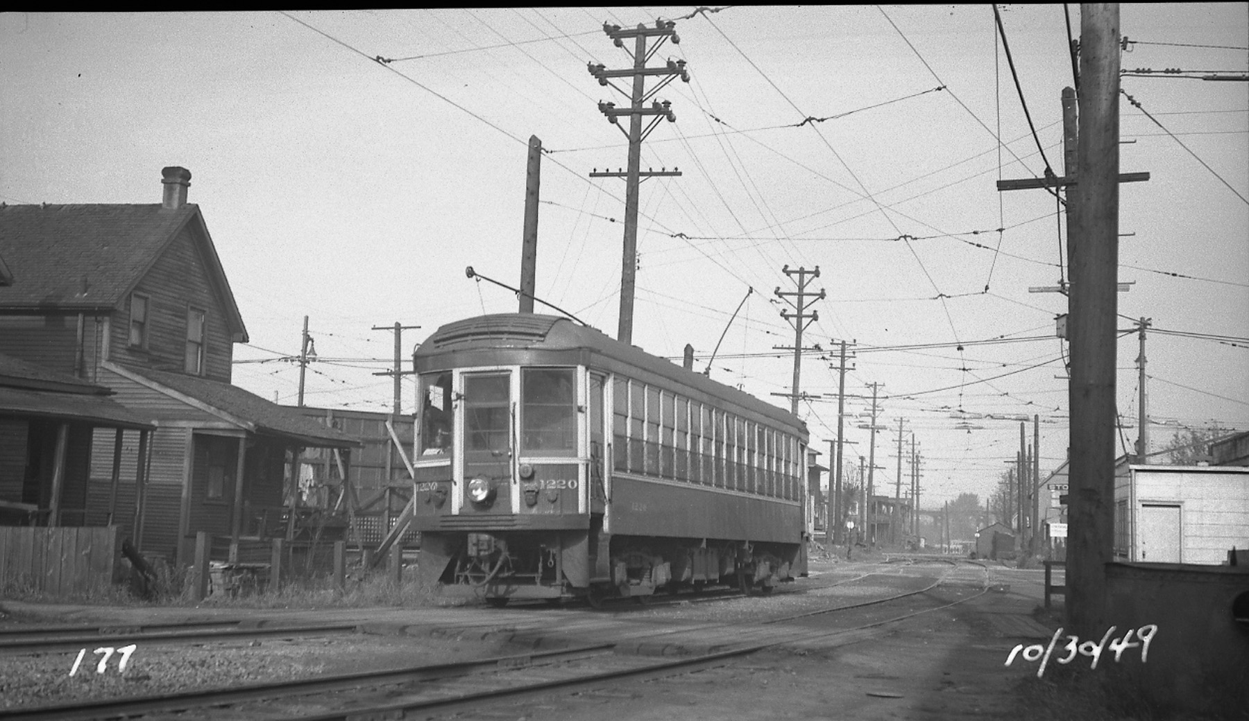 Black and white photo of historic tram number 1220 on rails