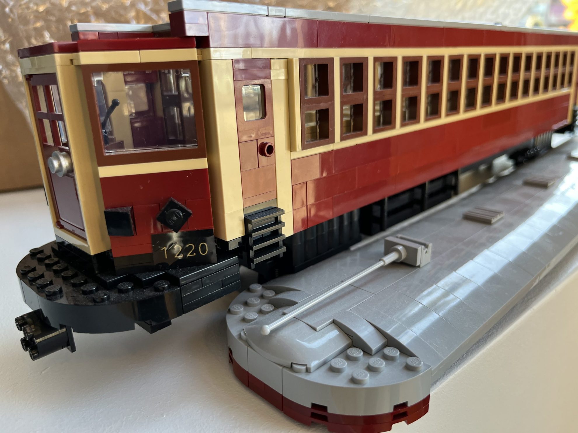 Closeup of Steveston Tram made of LEGO with roof removed placed beside it.