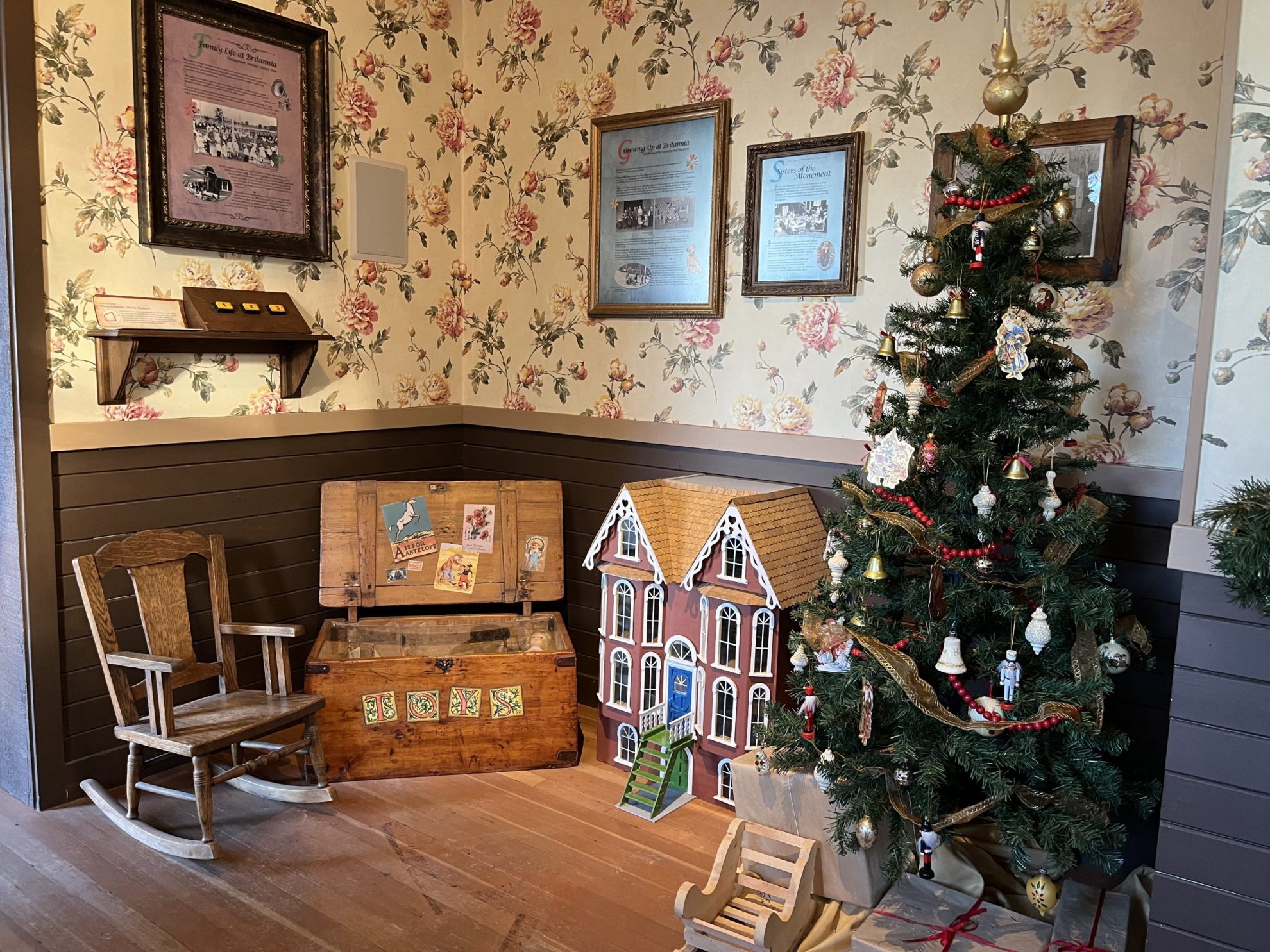 Historic display of living room with Christmas tree and doll house