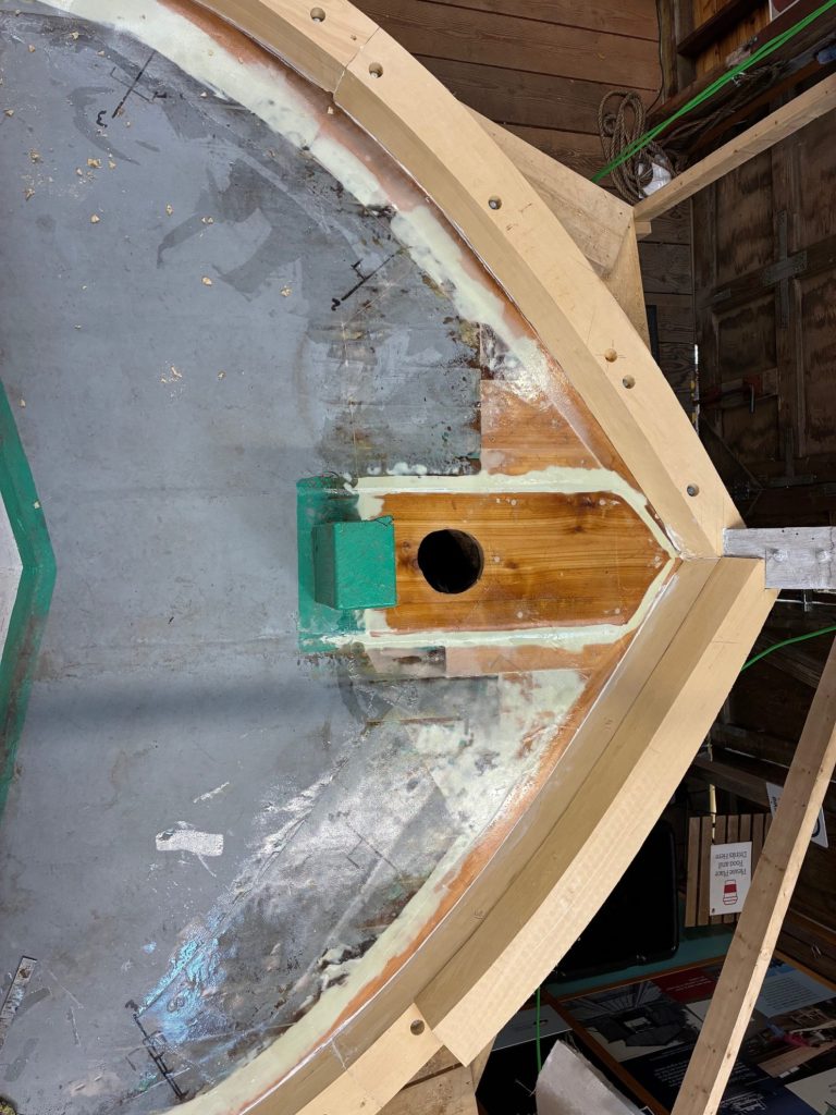 overhead look at construction of front pointed end of boat