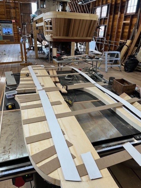 Curved wood laid out in the form of a boat bulkhead