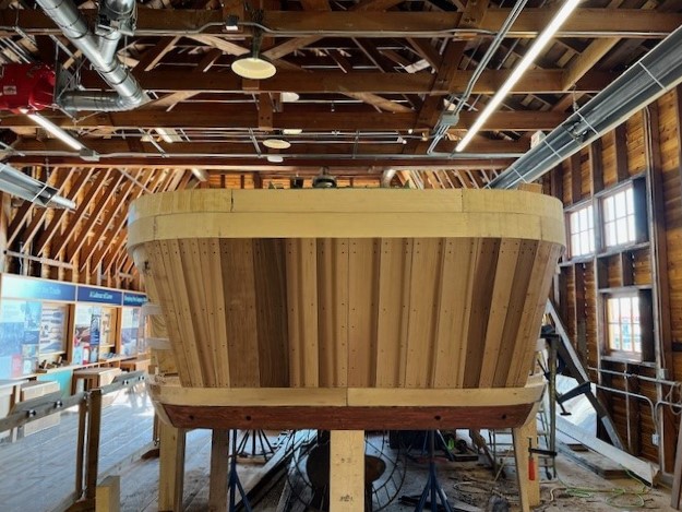 Exterior view of wooden planks arranged in bent formation around the Crystal S boat