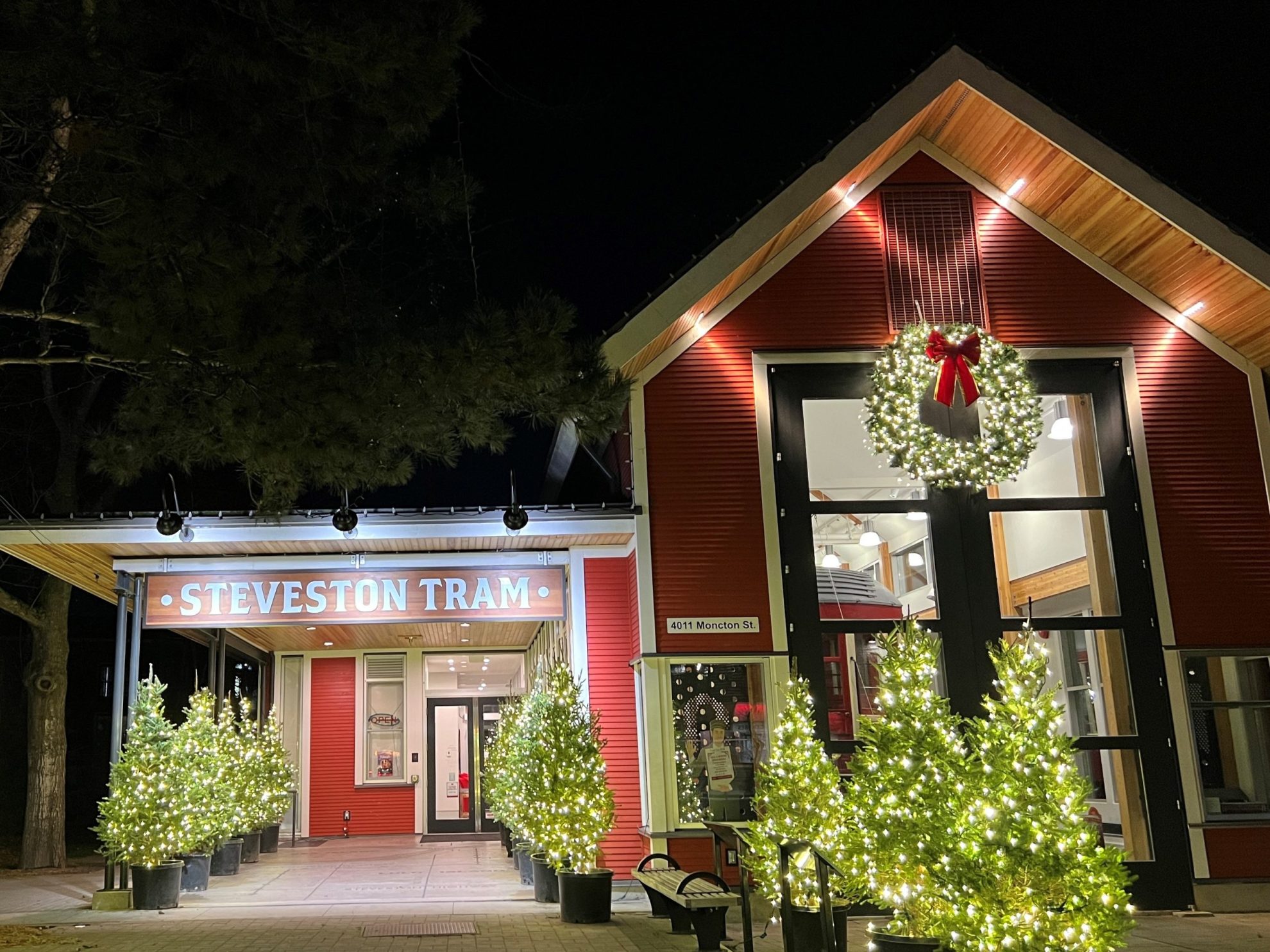 illuminated trees and wreath decorate the Steveston Tram building