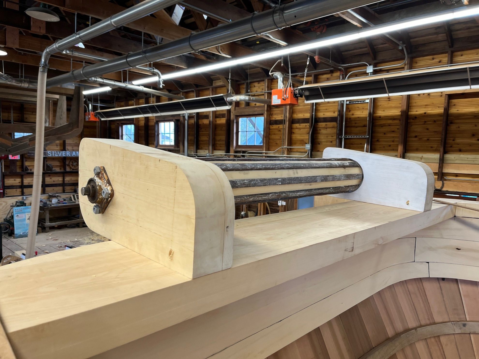 Close up of new lumber with metal pipe to form a net roller