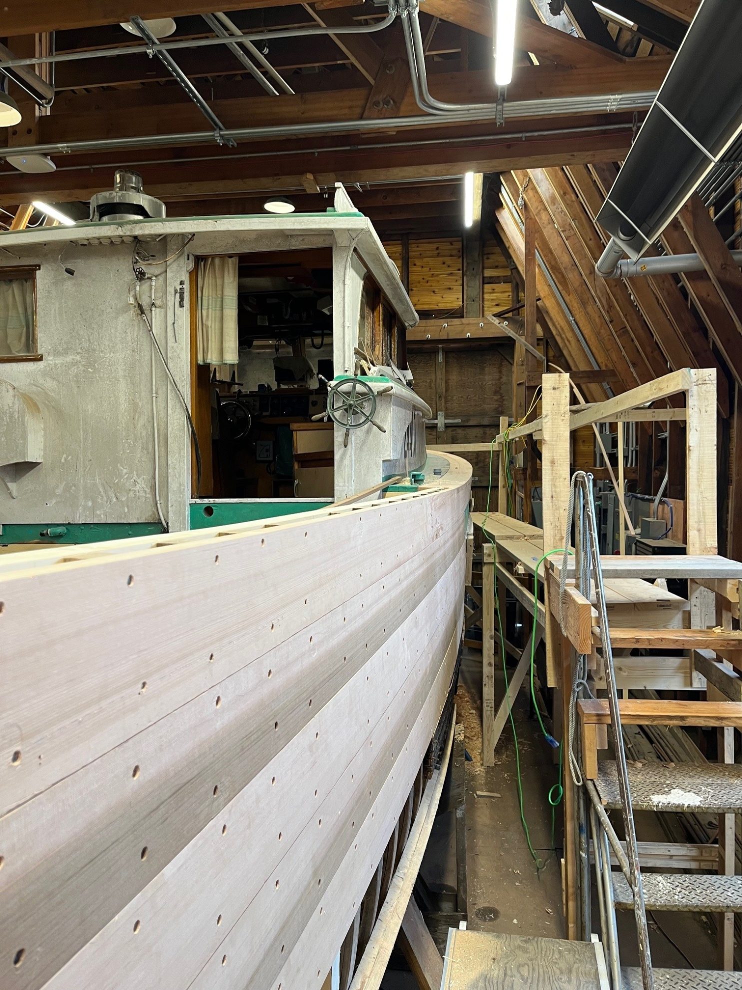 new lumber on a wooden fishing boat with stairs leading up the side