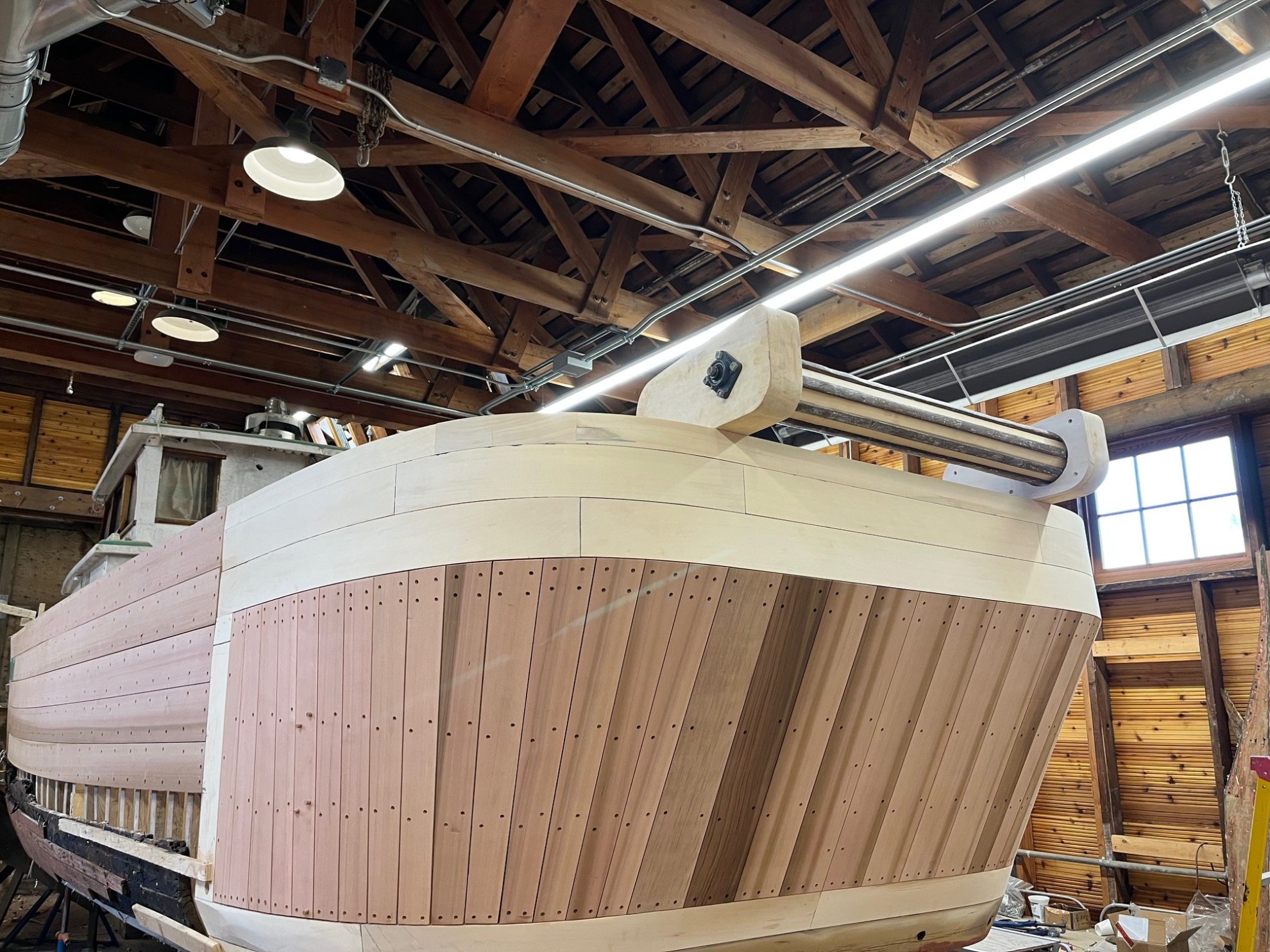 New lumber and a metal pipe forming a net roller for a fishing boat