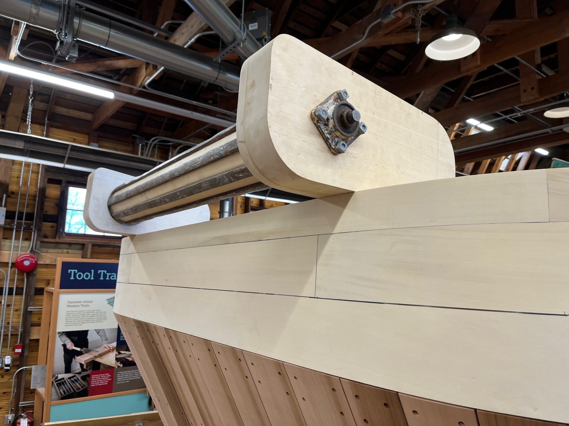 New lumber and a metal pipe forming a net roller for a fishing boat