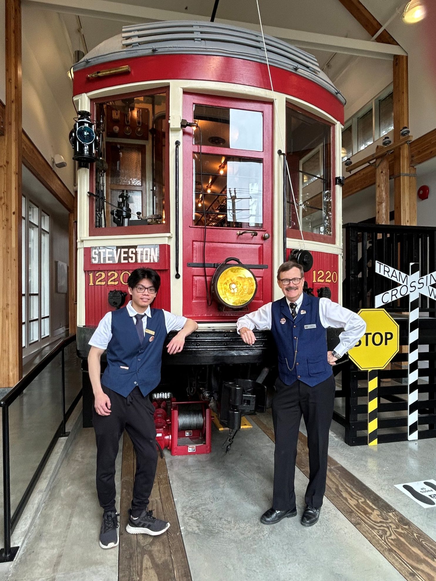 Two men dressed as tram conductors standing in front of the Steveston tram