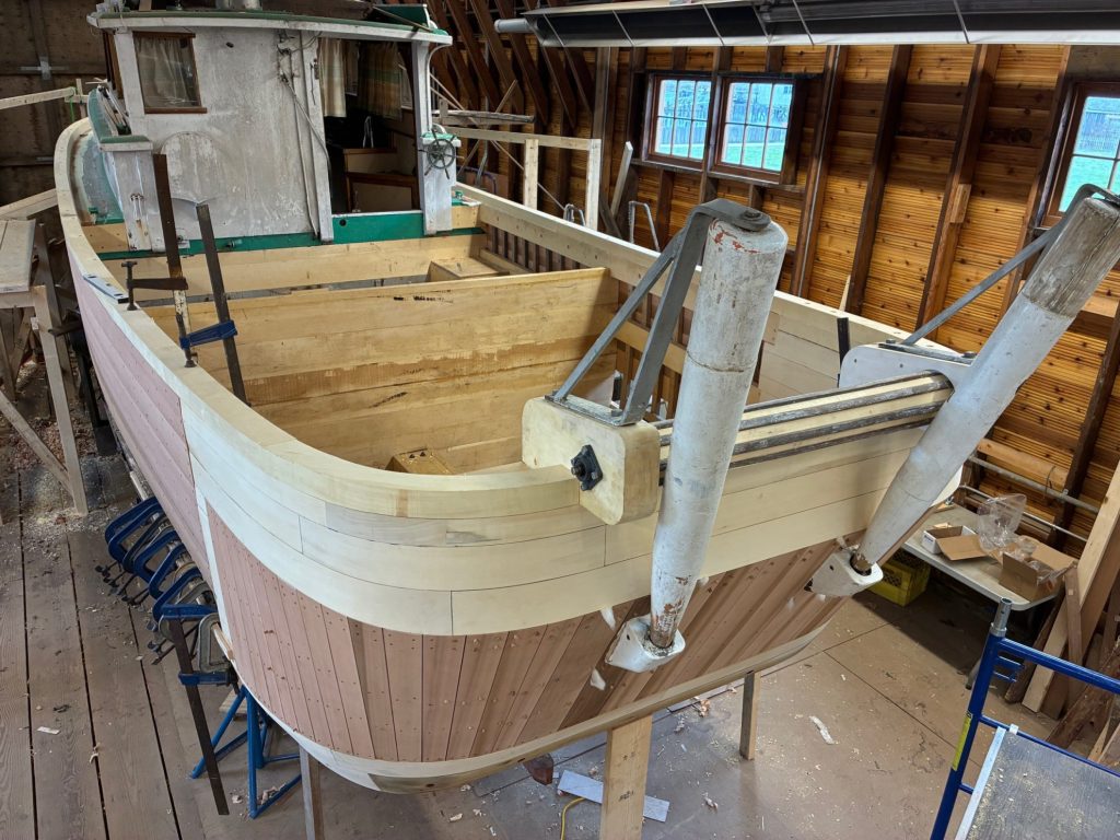 back end of a wooden fishing boat restored with new lumber
