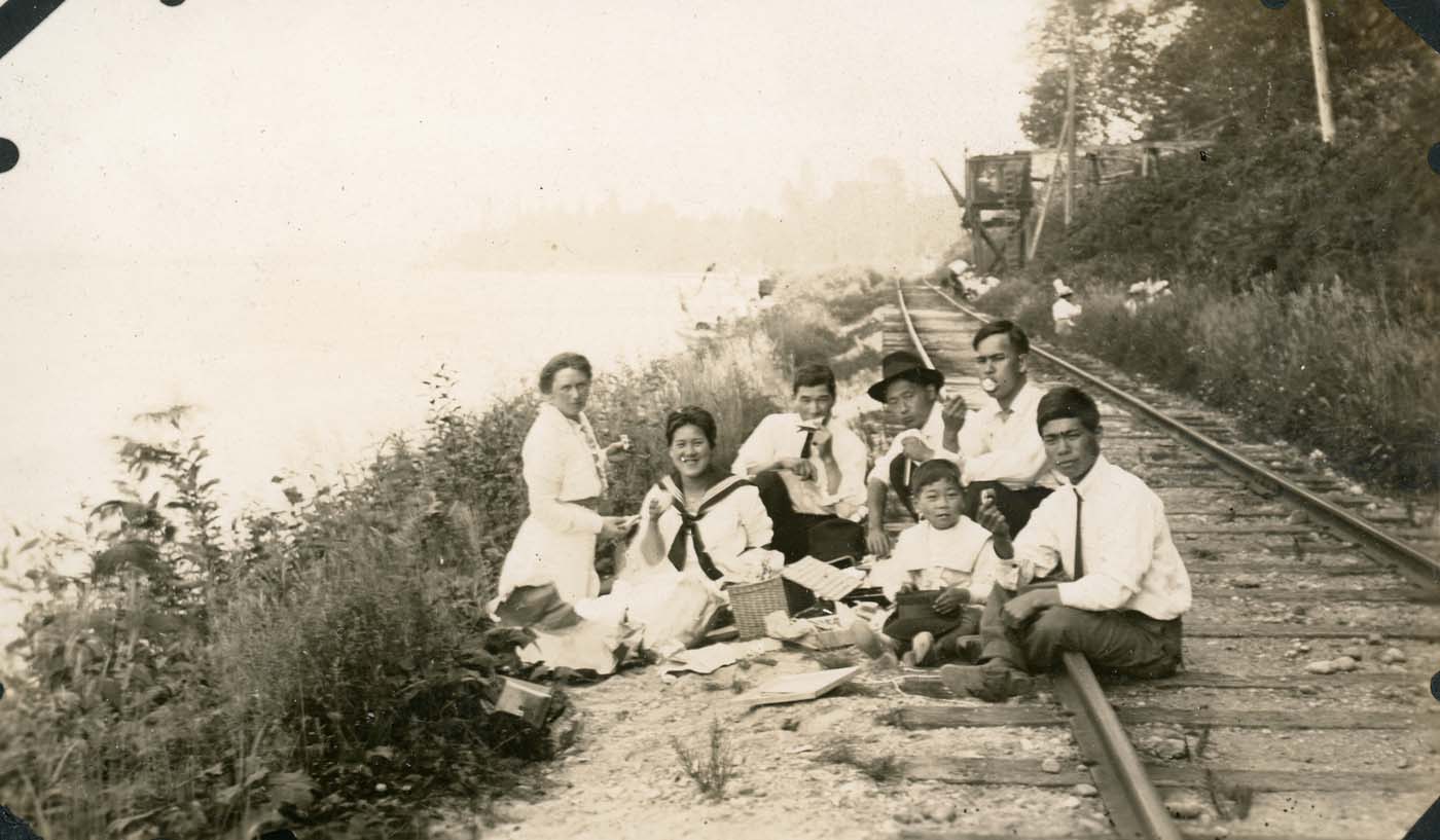 family picnicking on a railroad in early 1900s