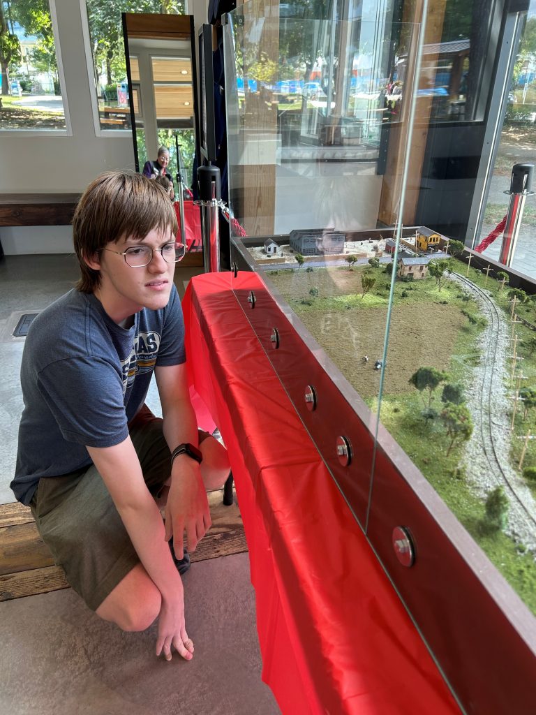 Youth with model tram display